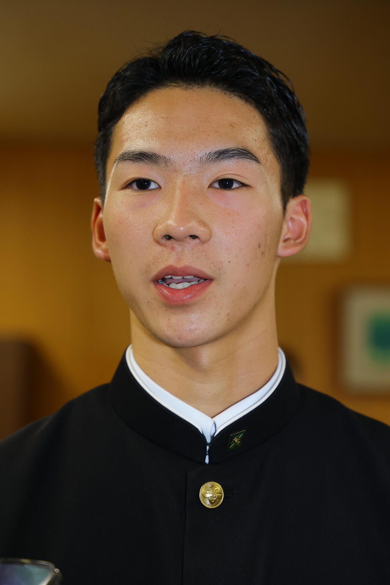 指名あいさつを受けた日本ハムドラフト5位の大阪府立香里丘高校・岡本翔斗は記者の取材を受ける（撮影・上田博志）