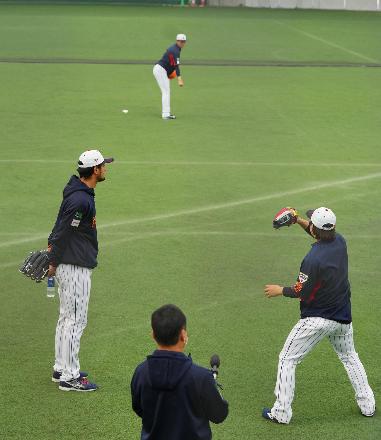 ダルビッシュ有（手前左）は打者のような位置に立ち佐々木朗希（中央）の球筋を見つめる（撮影・垰建太）