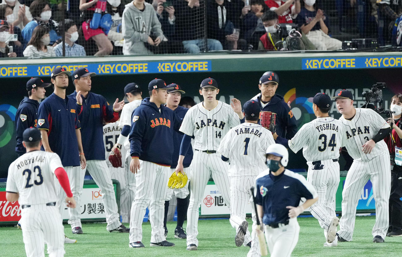日本対チェコ　3回表を無失点に抑えナインとタッチを交わす佐々木朗（中央）（撮影・横山健太）