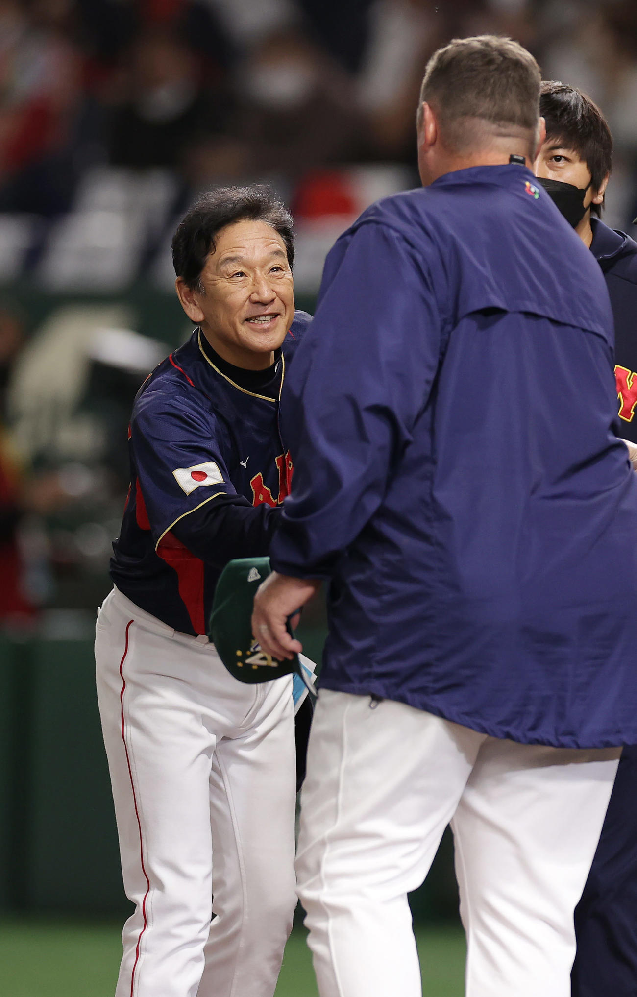 日本対オーストラリア　試合前、オーストラリアのニルソン監督（手前）とメンバー表を交換する栗山監督（撮影・前田充）
