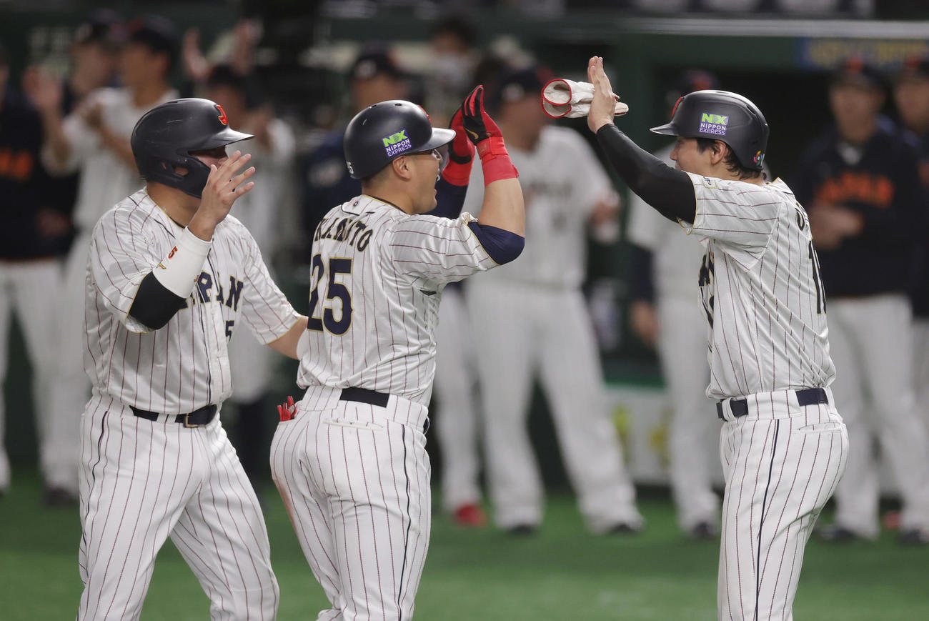 日本対イタリア　3回裏日本2死一、二塁、3点本塁打を放った岡本（中央）を迎える村上（左）と大谷（撮影・前田充）