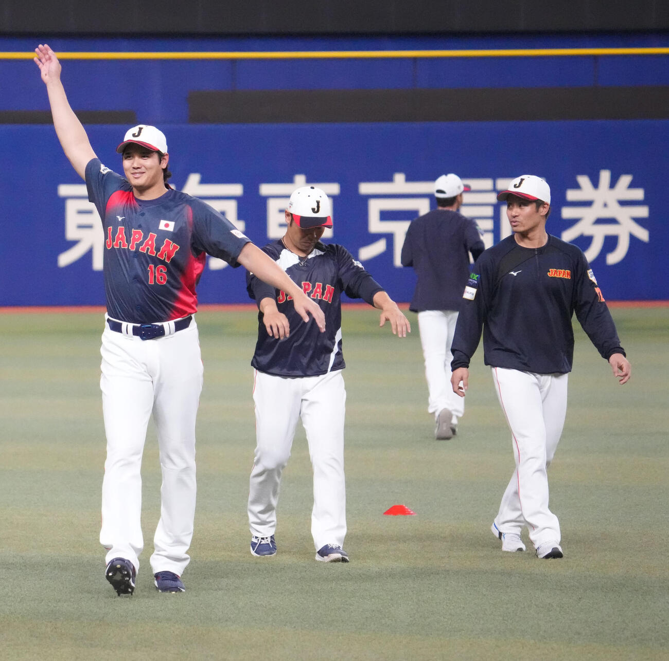 グラウンドで体をほぐす、左から大谷、近藤、坂本（撮影・森本幸一）