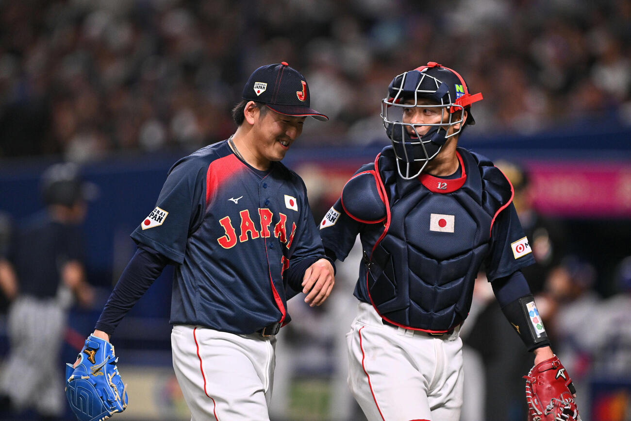 中日対日本　4回裏を投げ終えた日本2番手の隅田（左）は坂本と引き揚げる（撮影・滝沢徹郎）