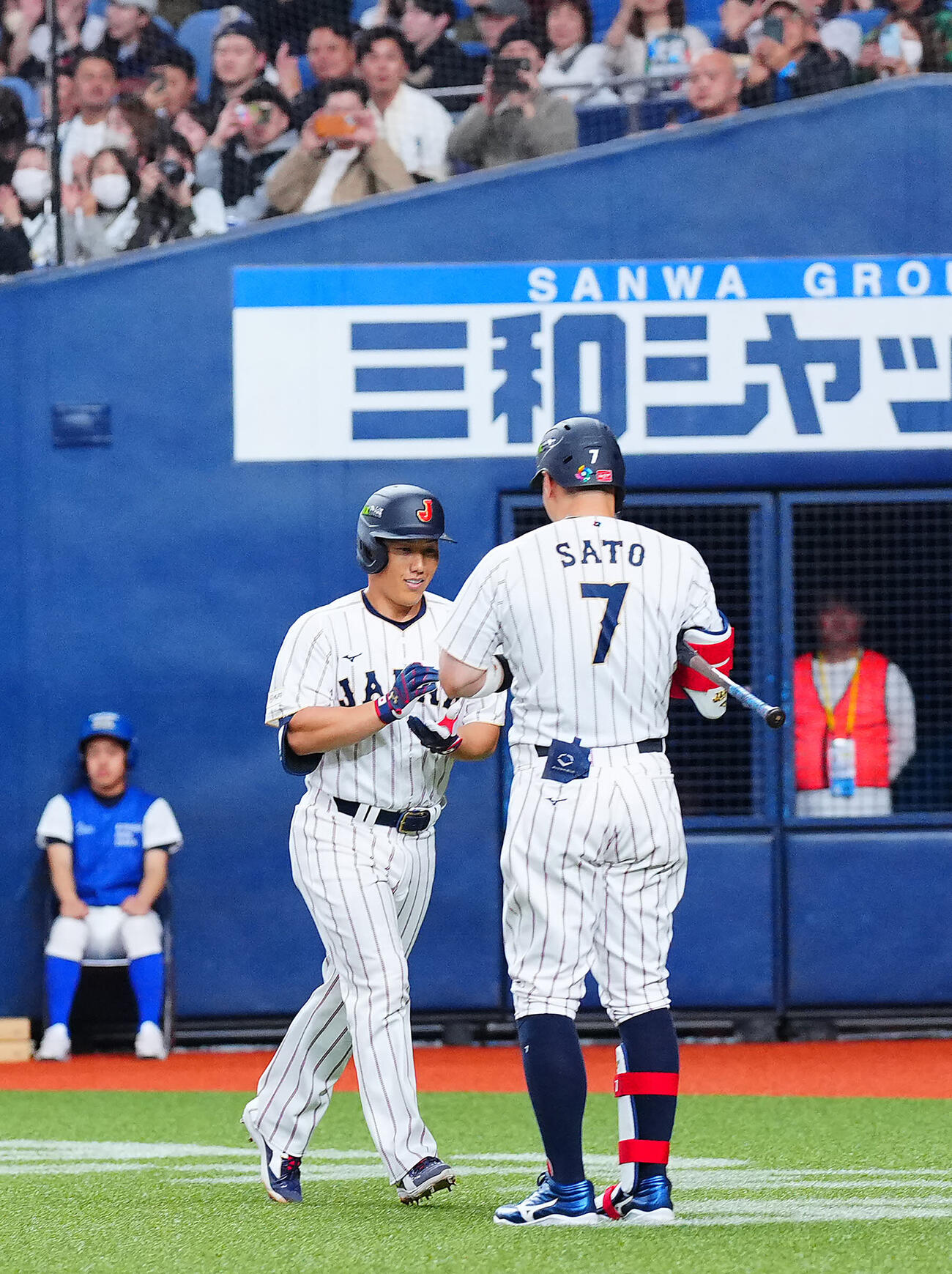 日本対オリックス　5回表日本1死、右越え本塁打を放ち出迎える佐藤（右）にポーズを決める吉田（撮影・垰建太）