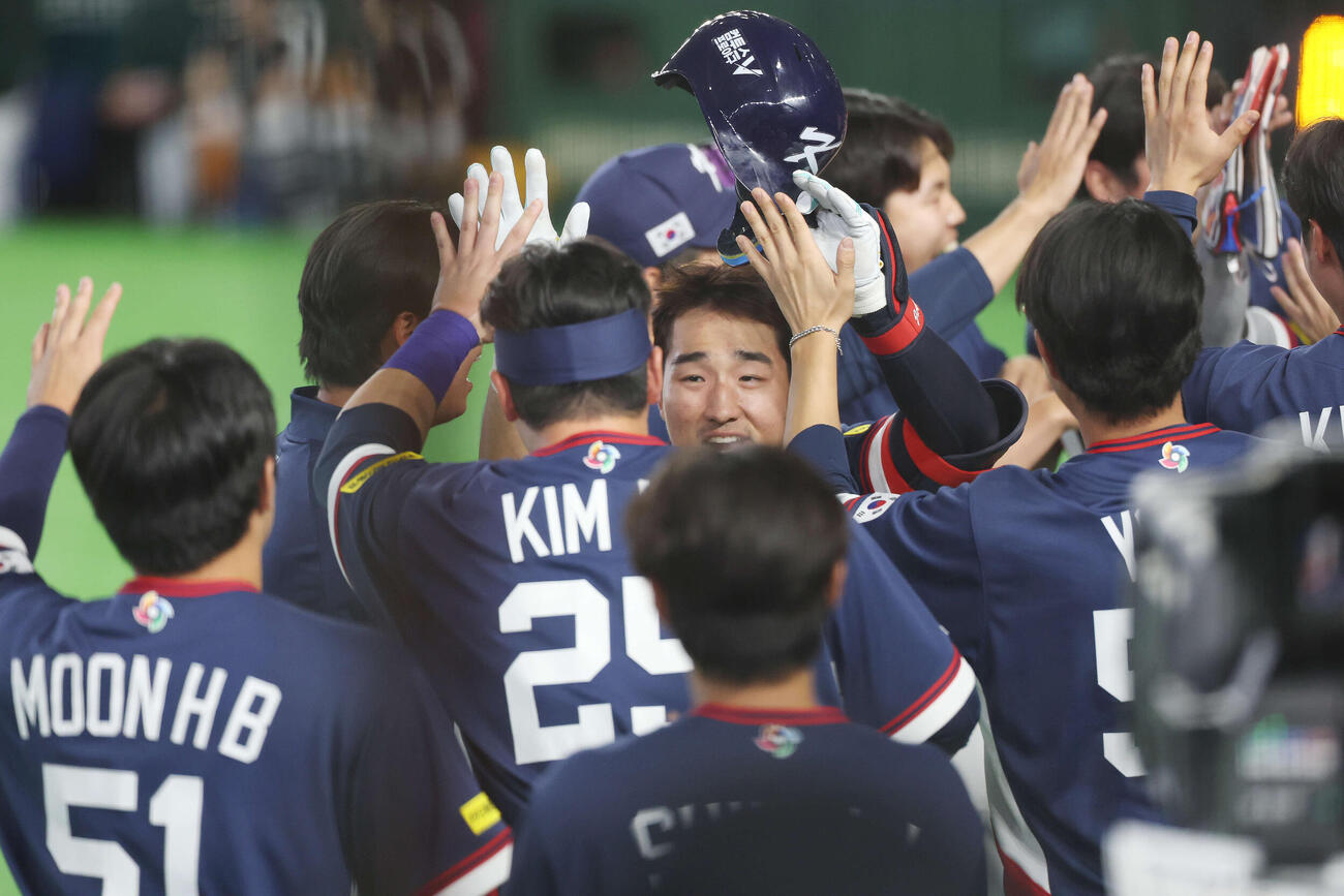 オーストラリア対韓国　9回表韓国1死一、三塁、中犠飛を放ちチームメートと喜ぶ安賢民（撮影・宮地輝）