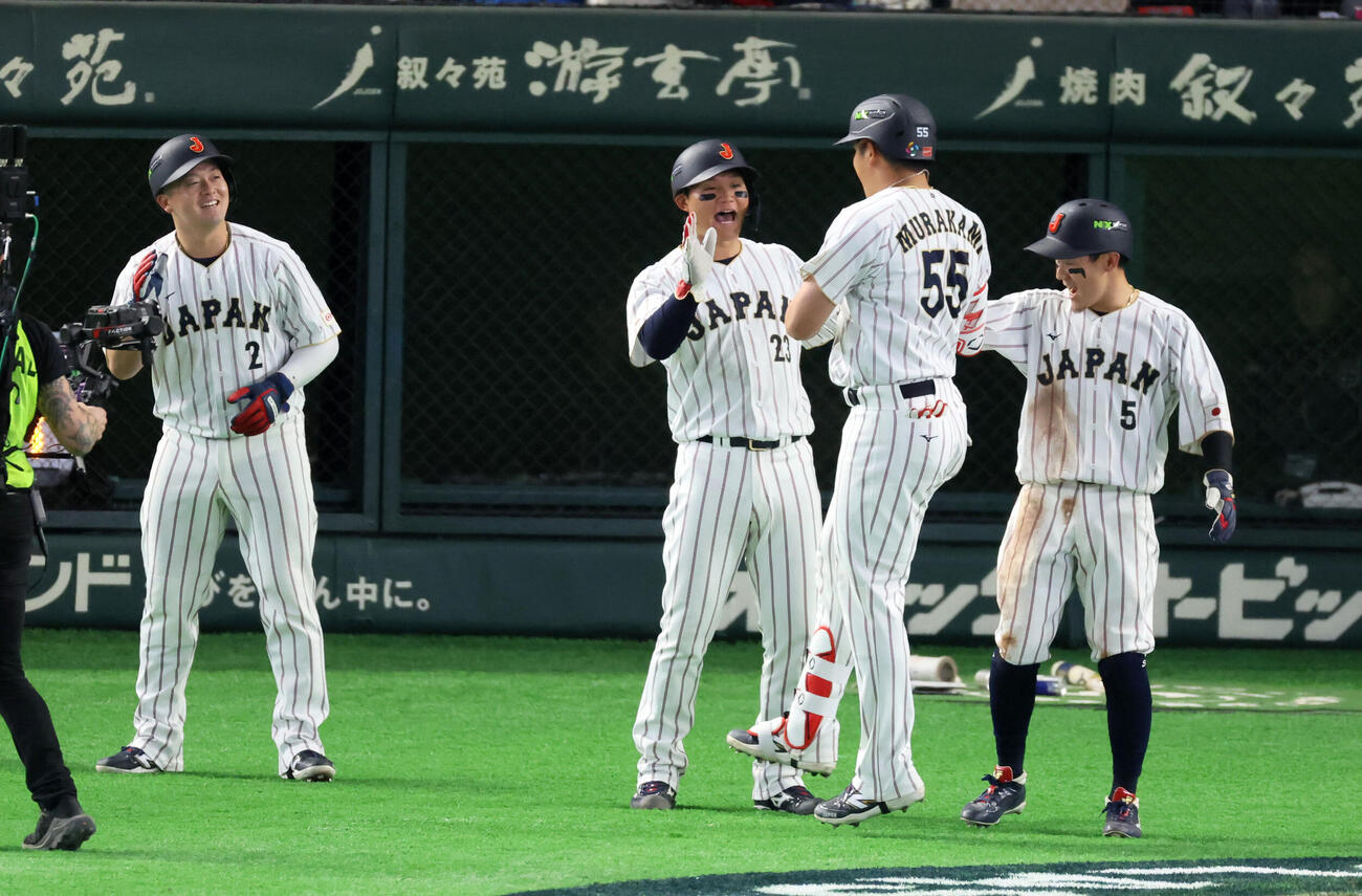 日本対チェコ　8回裏日本2死満塁塁、村上は中越え満塁本塁打を放ち左から牧、森下、ひとりおいて牧原大の出迎えを受け生還（撮影・加藤哉）