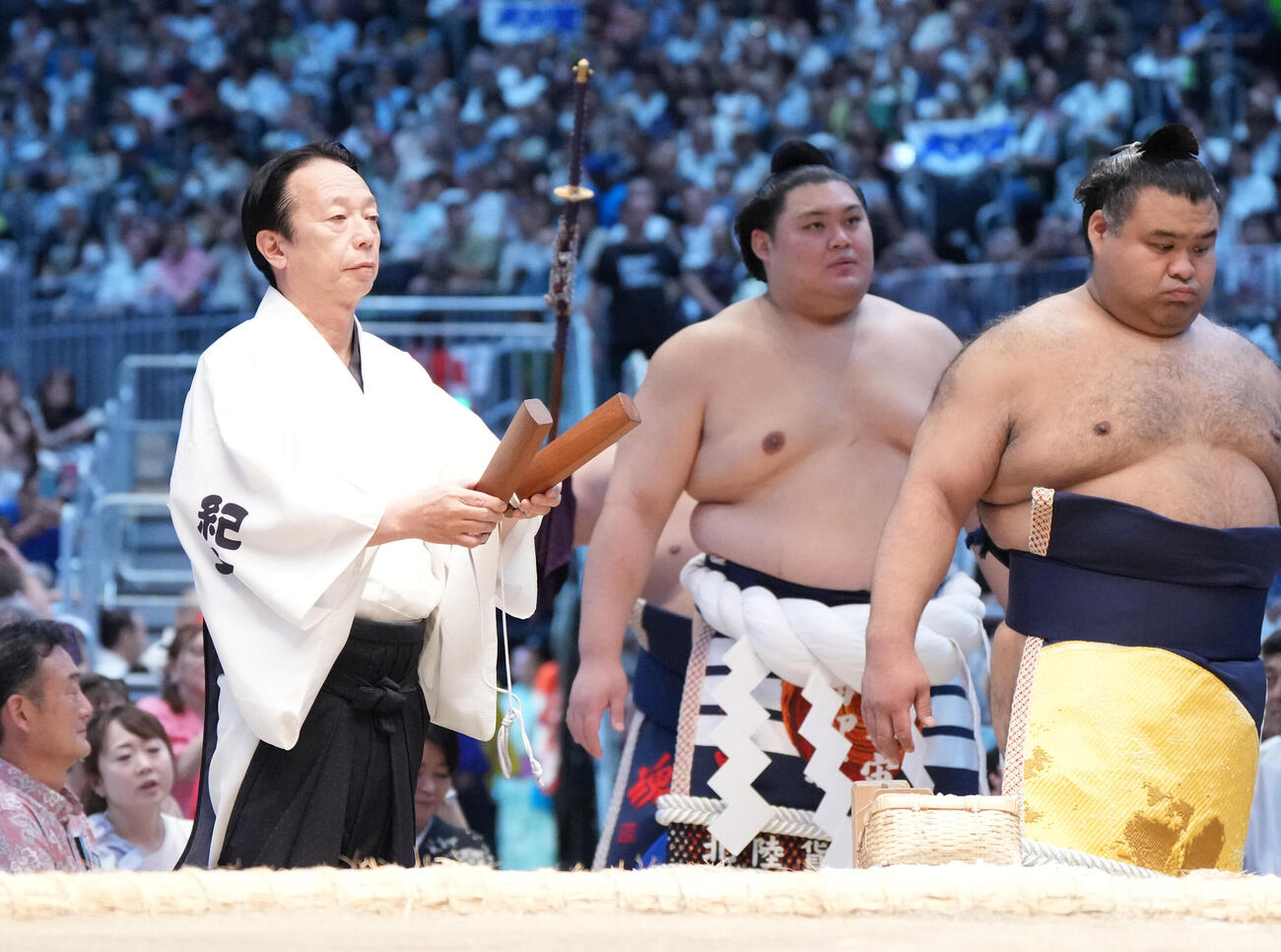 横綱土俵入りで拍子木をたたく呼び出しの克之（左）（撮影・森本幸一）