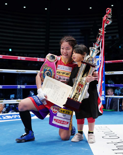 WBO女子世界スーパーフライ級タイトルマッチ　吉田実代（左）は石麗萍を破って王座を防衛し、娘と笑顔を見せる（撮影・加藤諒）