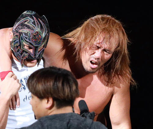 念願の大合掌直前にKENTAに急襲され、BUSHI（左）の肩を借りて引き揚げる内藤哲也（撮影・中島郁夫）