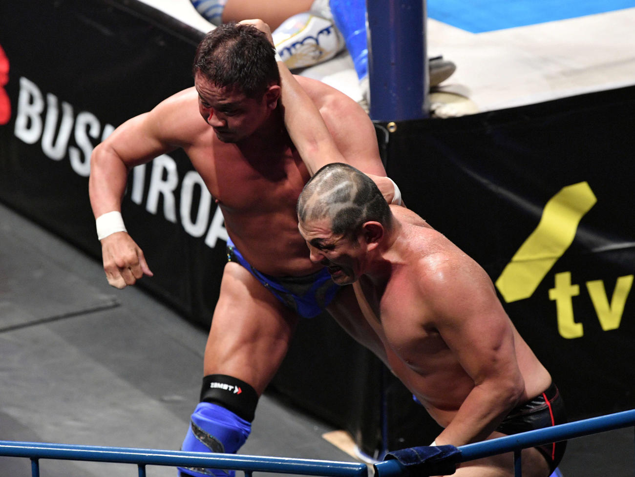 真壁、永田、飯伏、棚橋組対DOUKI、鈴木、ザック・セイバーJr、タイチ組　場外で永田（左）を攻める鈴木（撮影・滝沢徹郎）