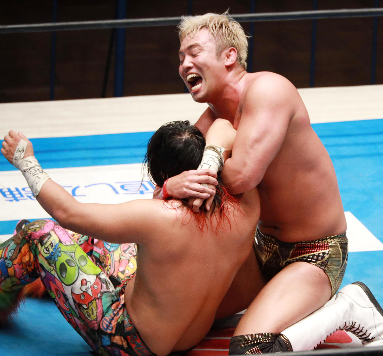 高橋ヒロム（左）にコブラクラッチを決めるオカダ・カズチカ（撮影・中島郁夫）