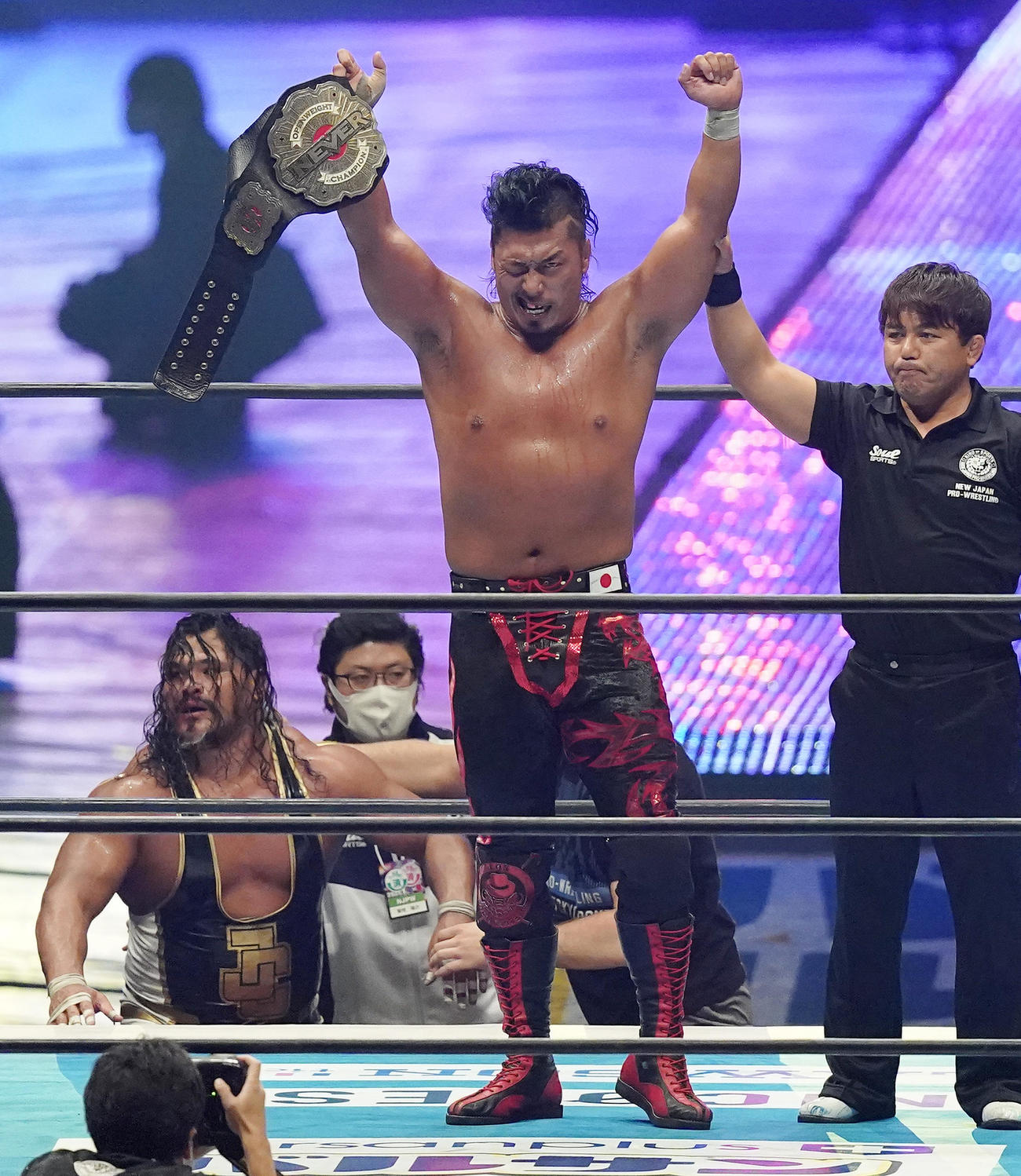 コブ（左下）に勝利し、NEVER無差別級王座の防衛に成功した鷹木は、ベルトを手にガッツポーズを見せる（撮影・菅敏）