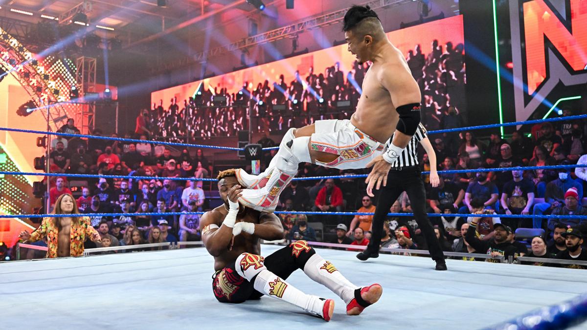 エノフェ（左）にミサイルキックを浴びせるKUSHIDA（C）2022 WWE, Inc. All Rights Reserved.