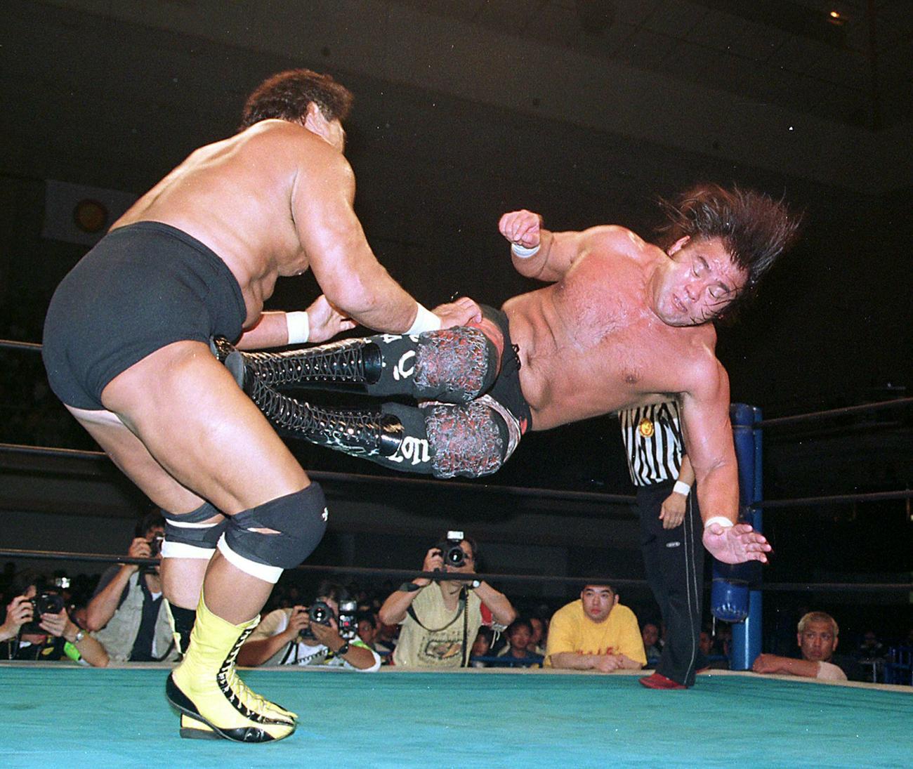 99年5月、IWGP選手権試合で天龍源一郎（左）に低空ドロップキックを見舞う武藤敬司