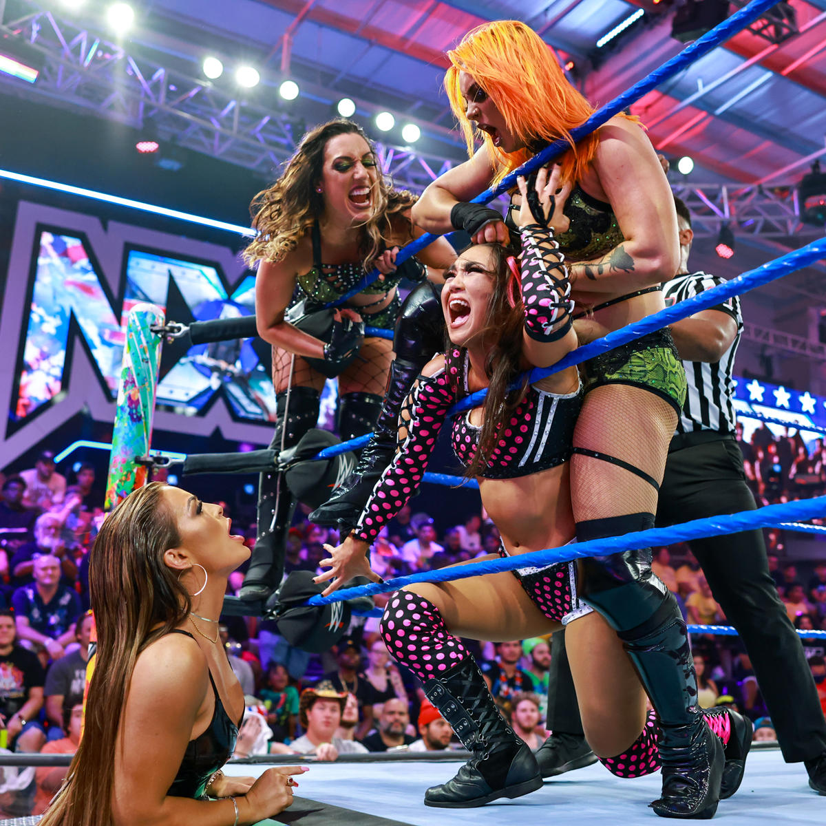 ロクサーヌ・ペレス（リング左から2番目）をユニット3人で痛めつけるNXT女子王者マンディ・ローズ（下）（C）2022 WWE, Inc. All Rights Reserved