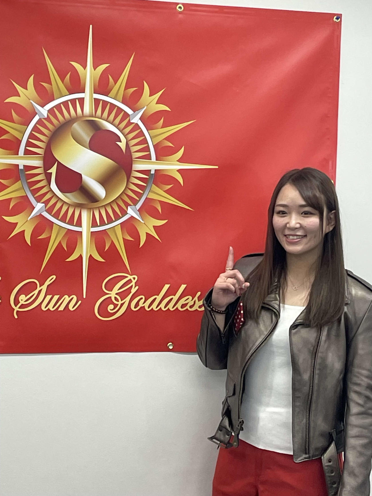 WWEとの契約が円満終了し、5月16日の日本復帰戦へ向けて記者会見に臨み、旗の前で記念撮影に応じるプロレスラーSareee