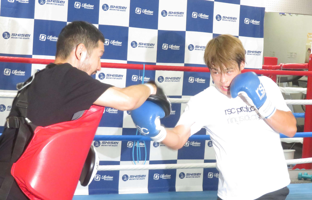 佐々木修平トレーナー（左）と激しいミット打ちを展開する東洋太平洋フェザー級王者堤駿斗
