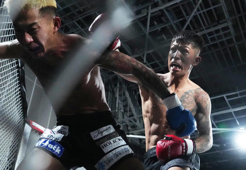 LARGE HIGH（左）にKOのパンチを浴びせる外枦保尋（撮影・菅敏）