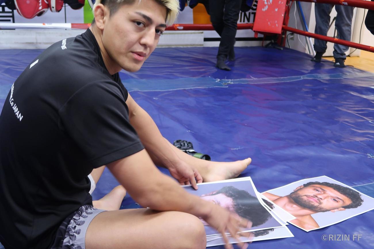 アゼルバイジャン大会へ向けて練習を公開し、対戦相手のヴガール・ケラモフの写真を手にする鈴木千裕（RIZIN提供）