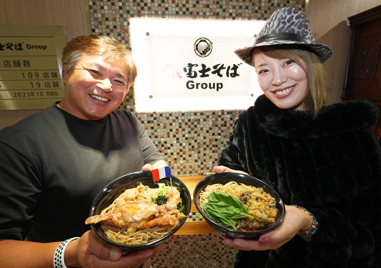 「富士そばdeおフランス」企画で試作品を手にする桜井まい（右）と富士そばの丹有樹社長（撮影・菅敏）
