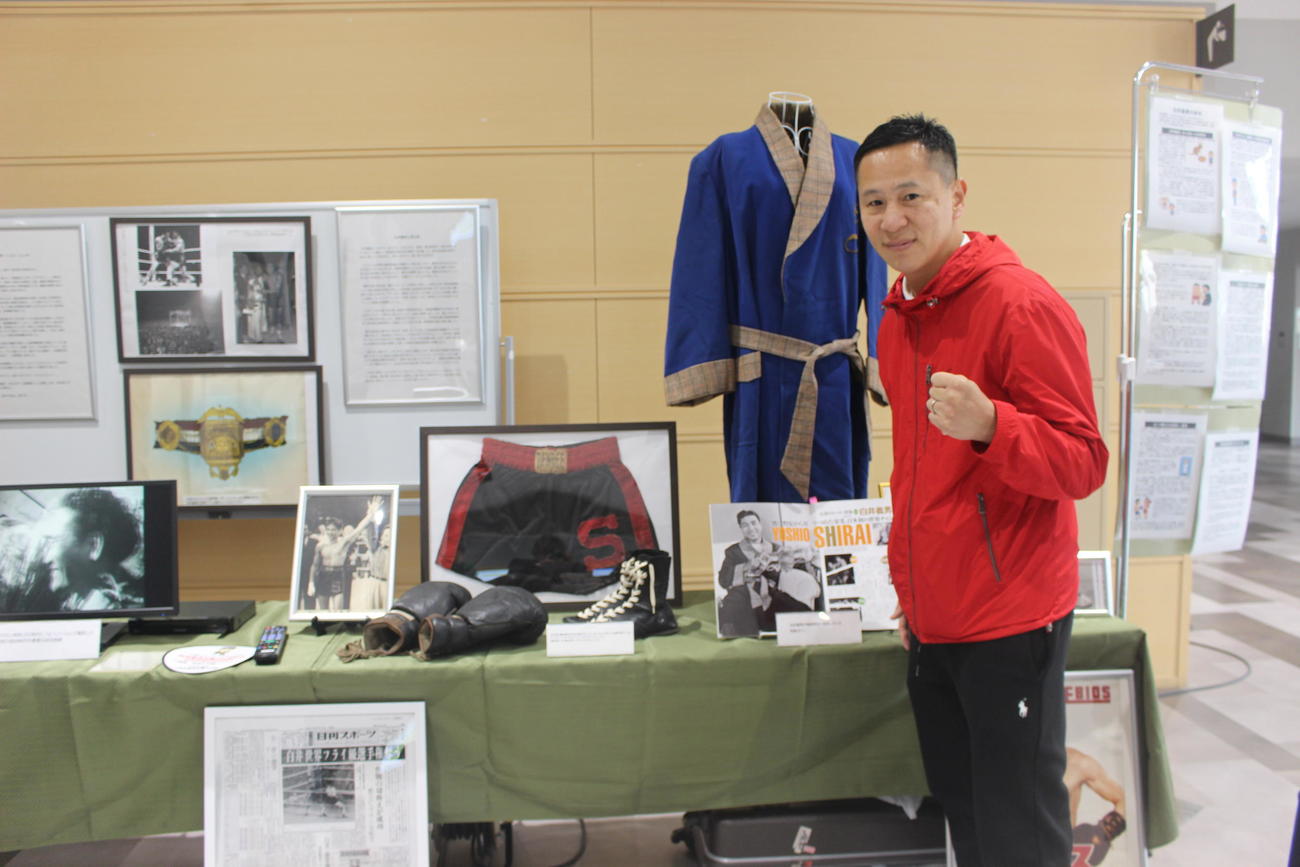 白井義男生誕100年イベントでゆかりの品々と記念撮影する元日本スーパーフェザー級王者の矢代義光氏（撮影・首藤正徳）