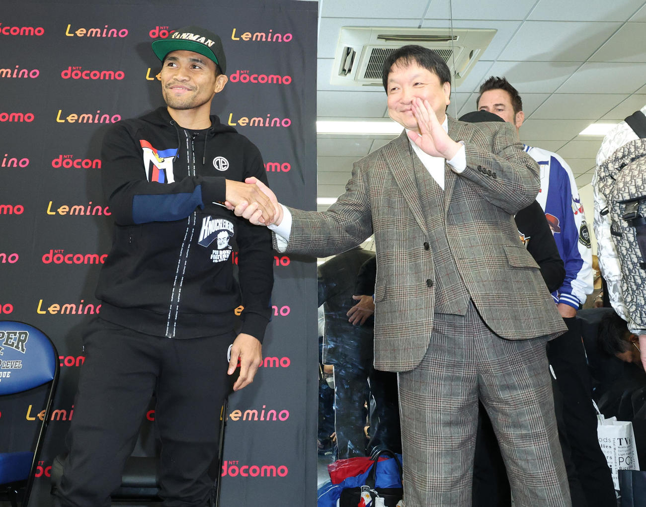 大橋会長（右）と握手するWBAスーパー、IBF世界スーパーバンタム級王者タパレス（撮影・中島郁夫）