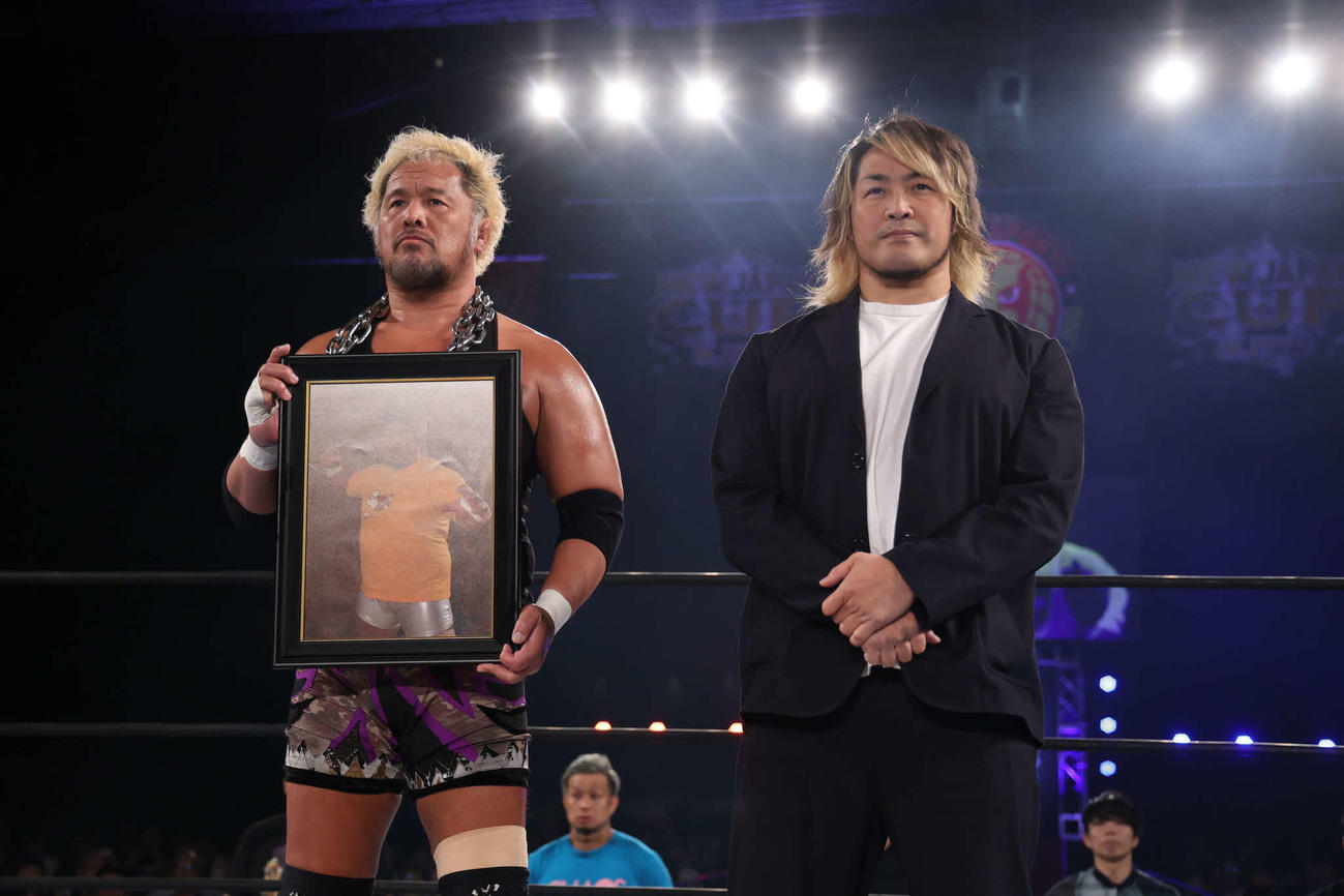 吉江豊さんの遺影を持つ真壁刀義とIWGPタッグ王座を獲得した時のパートナー棚橋弘至（写真提供・新日本プロレス）