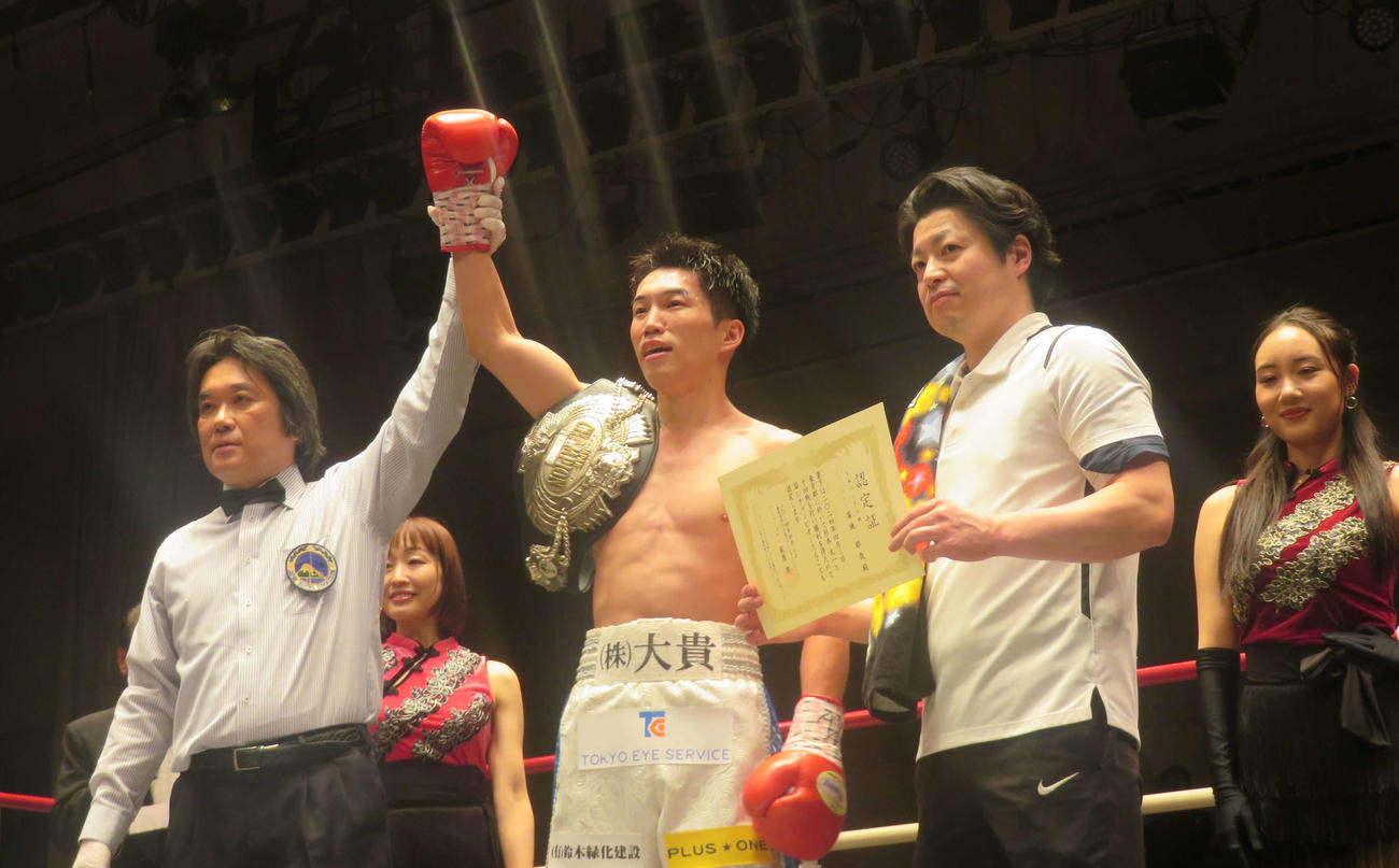 勝ち名乗りを受ける日本バンタム級新王者富施郁哉（中央）。右は町田主計トレーナー