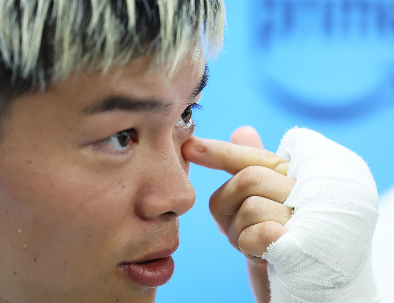 公開トレーニングを前に会見に臨んだ那須川は左目の下のキズについて話す（撮影・足立雅史）