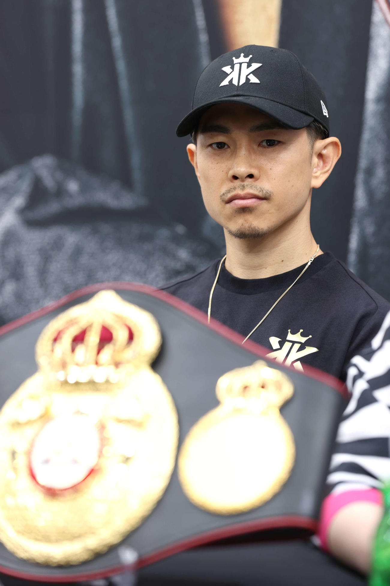 WBA、IBF世界スーパーフライ級統一選の調印式でグローブを見詰める井岡（撮影・水谷安孝）