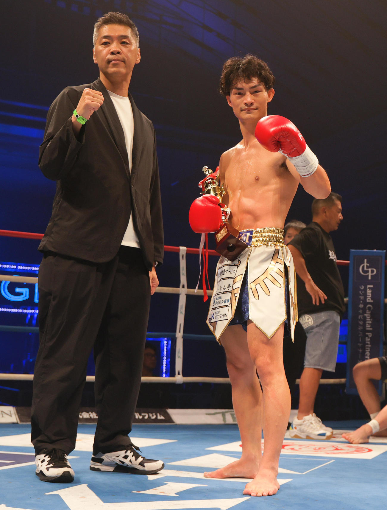 第3試合・スーパー・フェザー級　高橋直輝対松本涼雅　勝利を収めトロフィーを手に記念撮影する高橋（撮影・上山淳一）