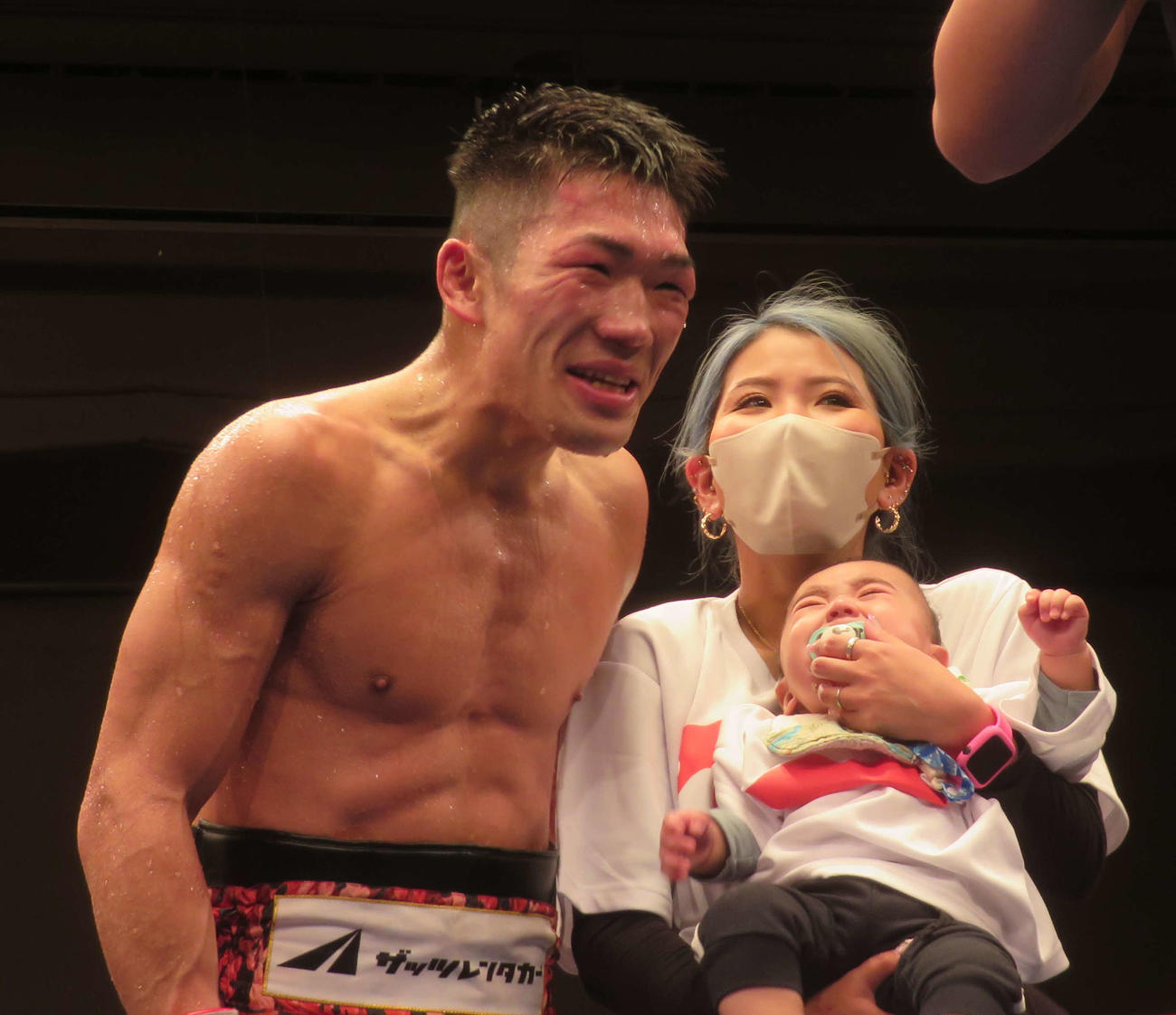 昨年7月に生まれた息子をリングに挙げて勝利を分かち合う東洋太平洋、WBOアジア・パシフィック・スーパーライト級王者永田大士（左）