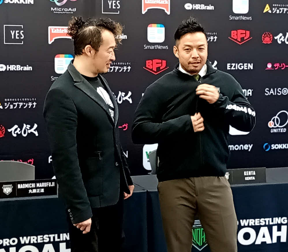 丸藤正道（左）からもらったノア・ジャージーに文句を言いながら袖を通したKENTAだったが、表情はうれしそうだった