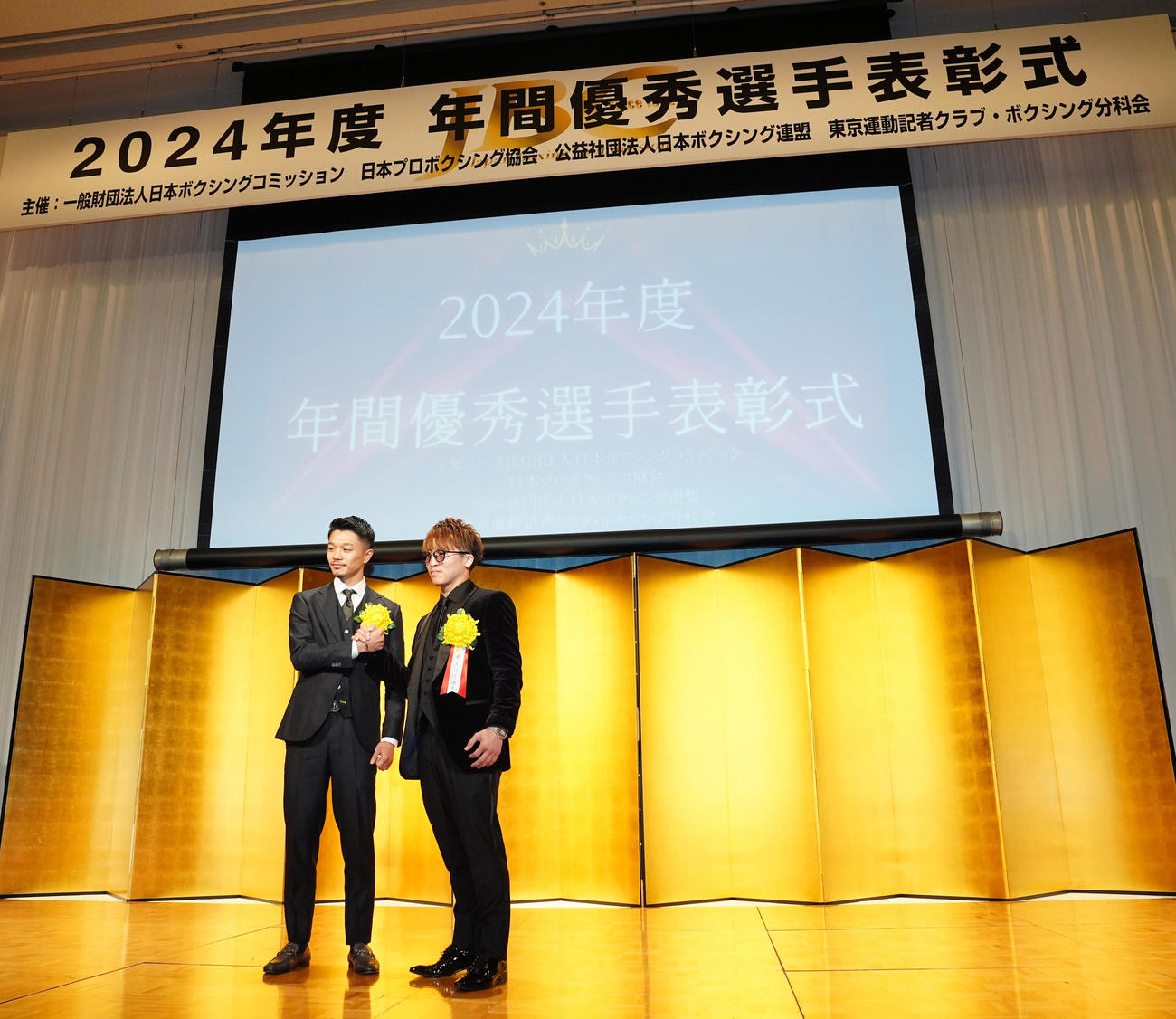 年間表彰式で握手を交わす最優秀選手賞の井上尚（右）と技能賞の中谷（撮影・江口和貴）