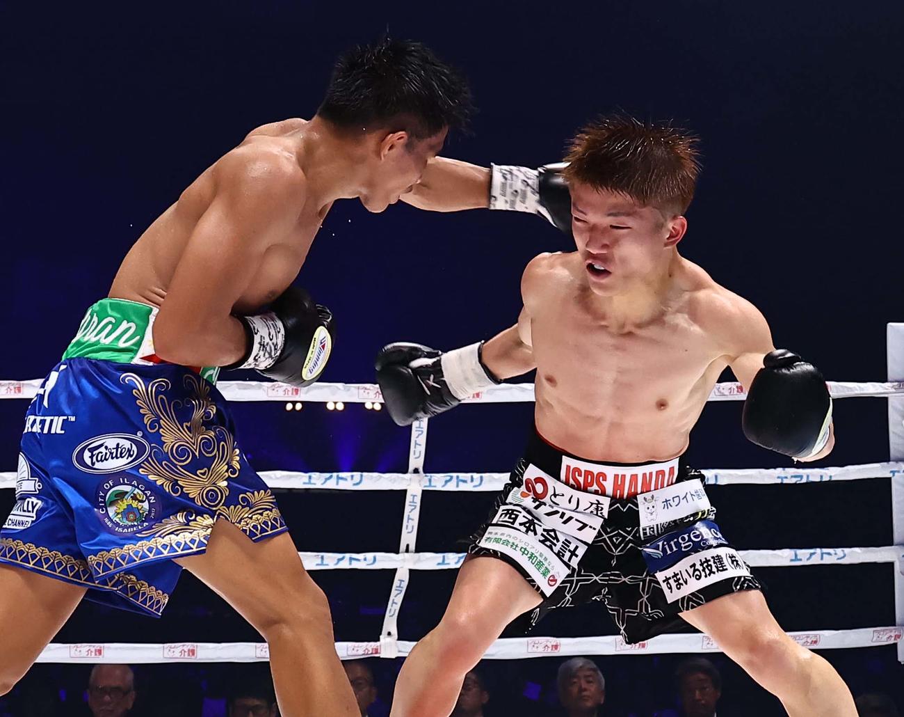 IBF世界ミニマム級タイトルマッチ　12回、タドゥラン（左）のパンチを浴びる重岡（撮影・上田博志）