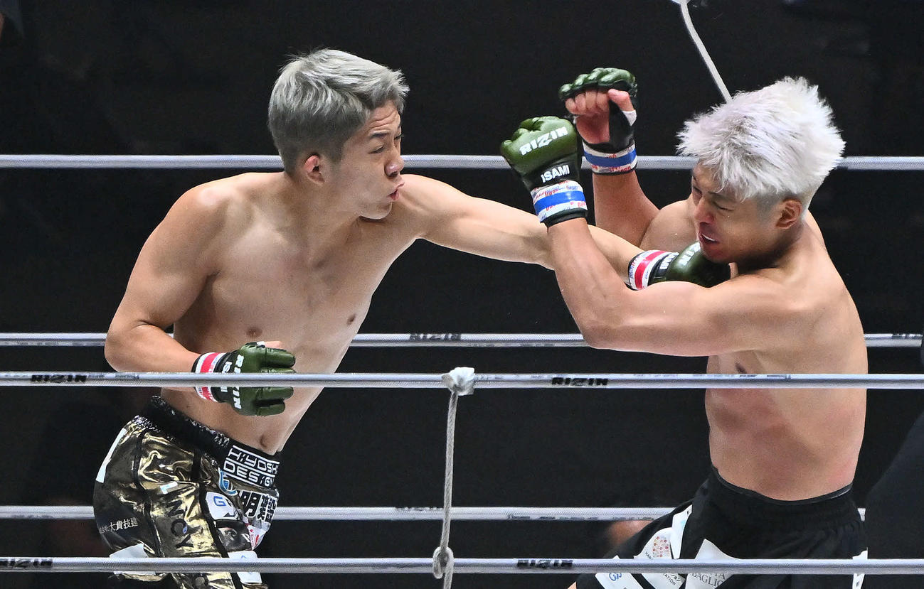 1回、秋元（左）は赤田にパンチを打ち込む（撮影・滝沢徹郎）　