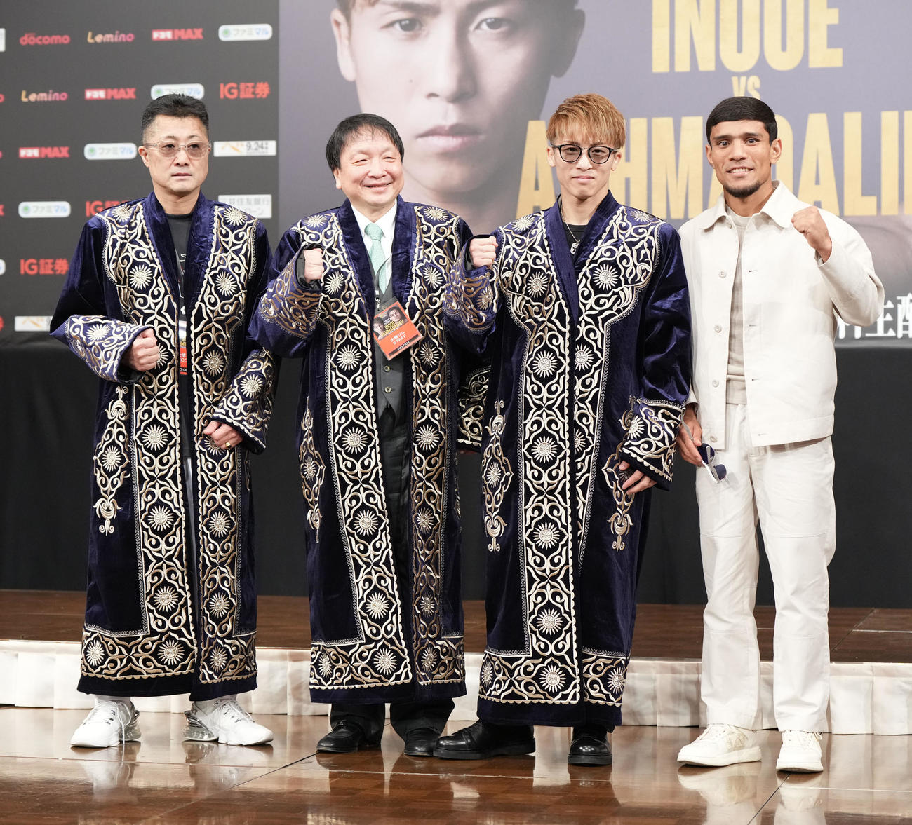 会見後、アフマダリエフ（右）からプレゼントされた民族衣装のチャパンを着用し記念撮影に納まる左から井上真吾トレーナー、大橋会長、井上（撮影・森本幸一）