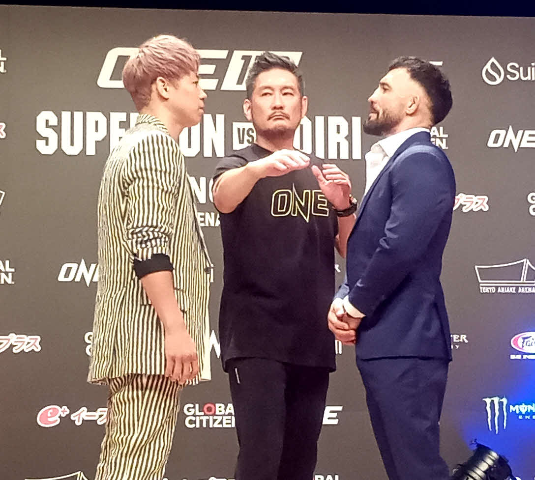 武尊（左）とフェイスオフするデニス・ピューリック（中央はONEチャトリCEO）（25年9月撮影）