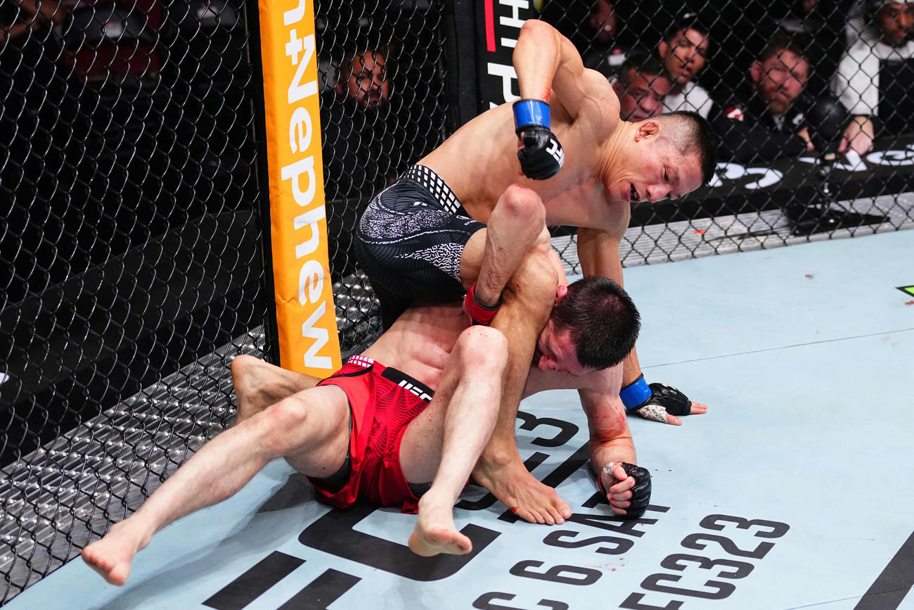 UFCフライ級11位タギル・ウランベコフ（下）に対し、右拳を振り下ろす堀口恭司（C）Zuffa LLC／UFC
