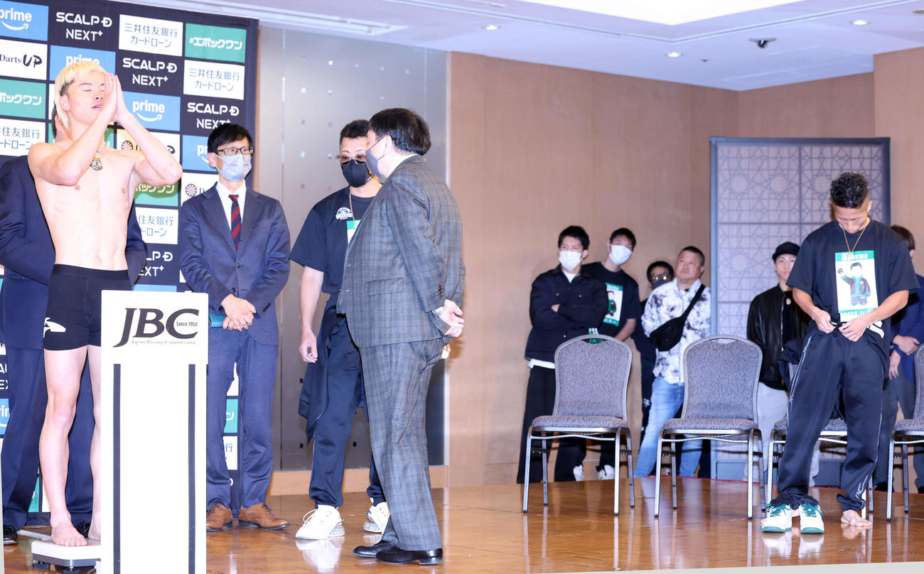 那須川天心対井上拓真　計量をクリアし合掌する那須川天心（左）。右は井上拓真（撮影・浅見桂子）