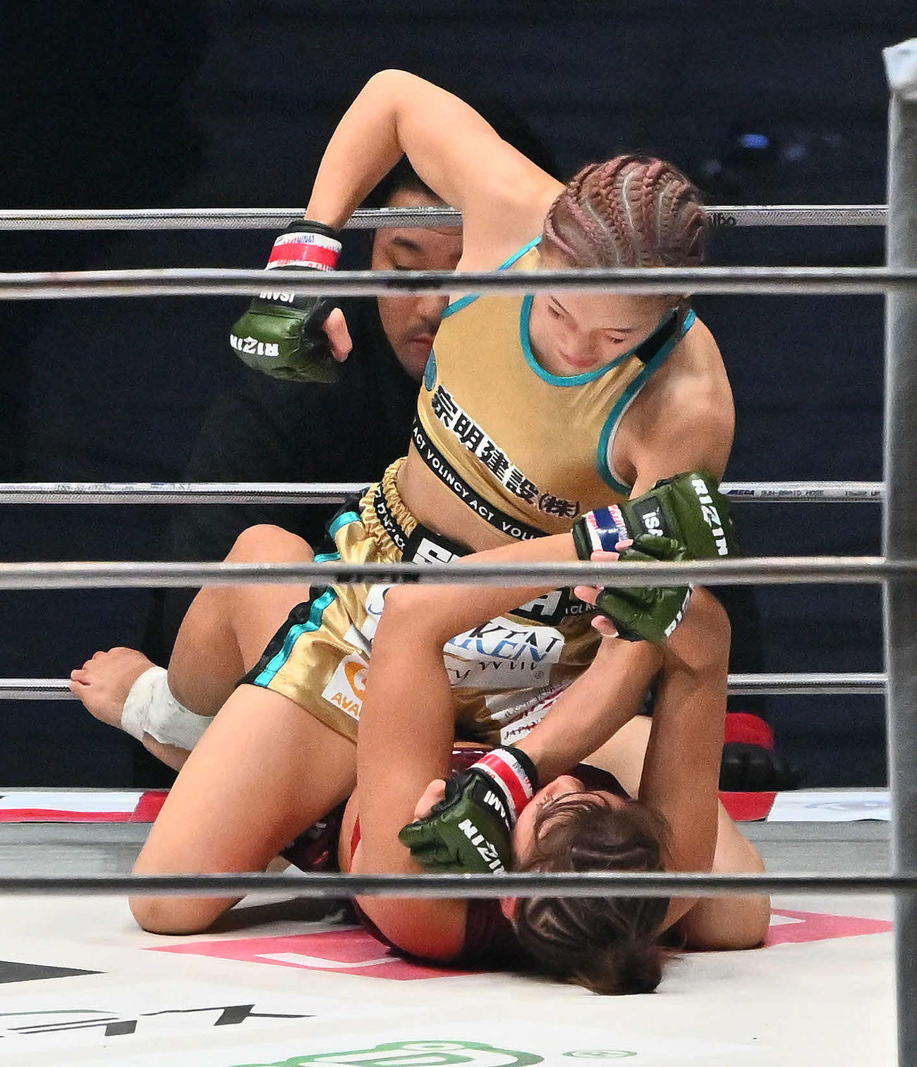 1回、伊沢星花（上）はRENAにパンチを打ち込む（撮影・滝沢徹郎）