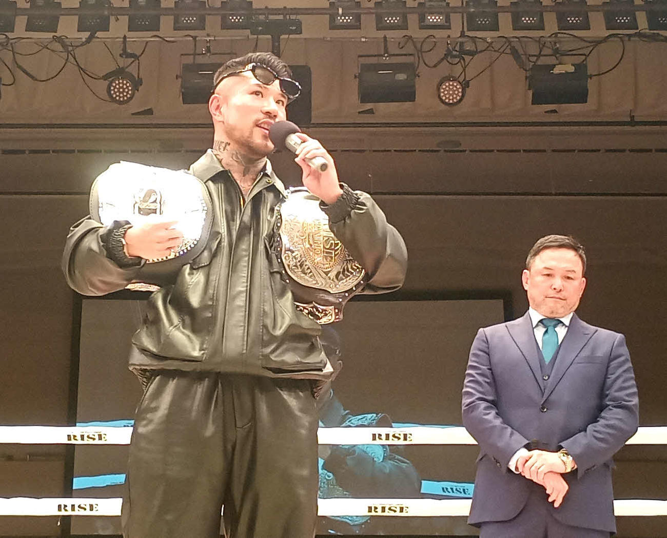 光り輝くベルトを返上した中村寛（右はRISE伊藤隆代表）
