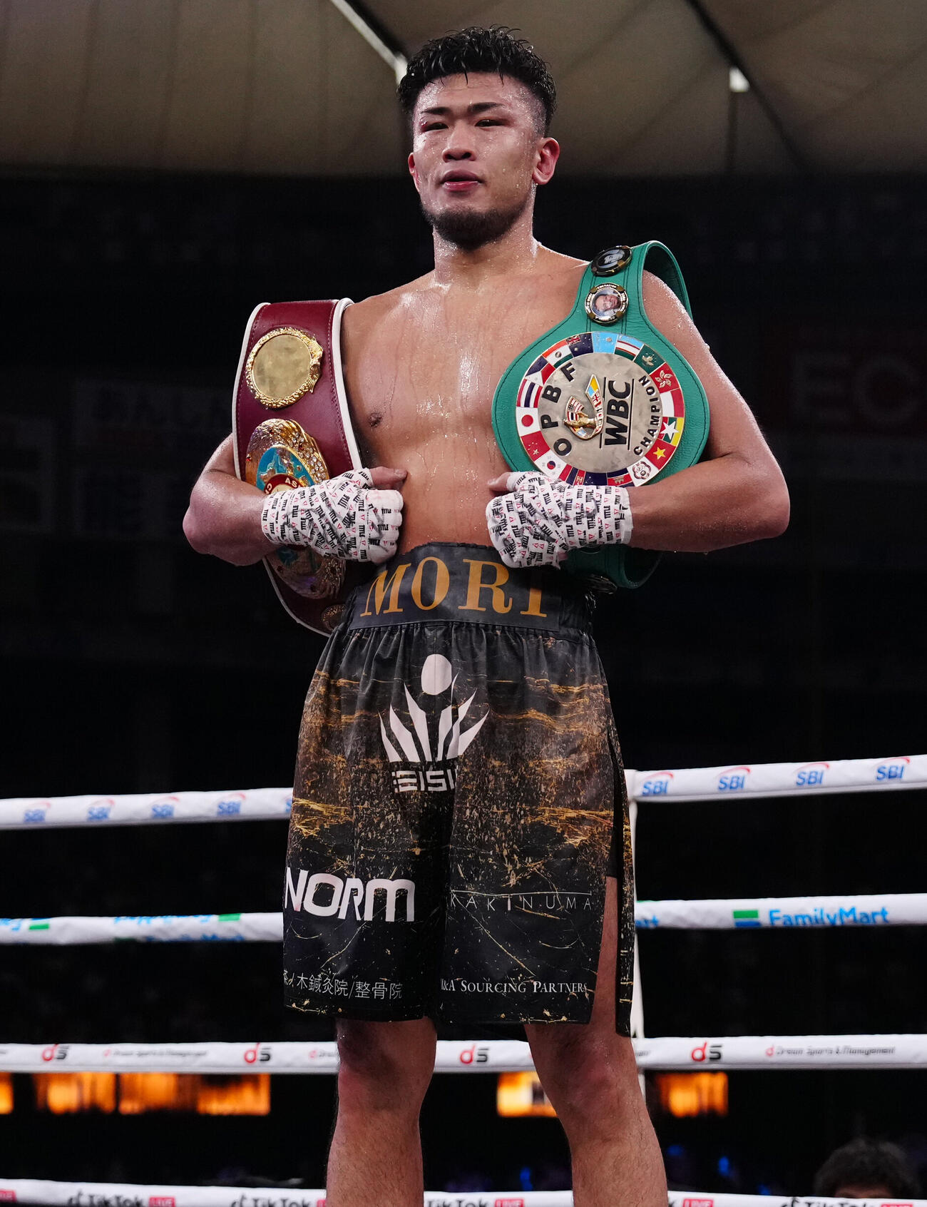 判定で勝利し2本のチャンピオンベルトを肩に写真に納まる森脇唯人（撮影・鈴木みどり）