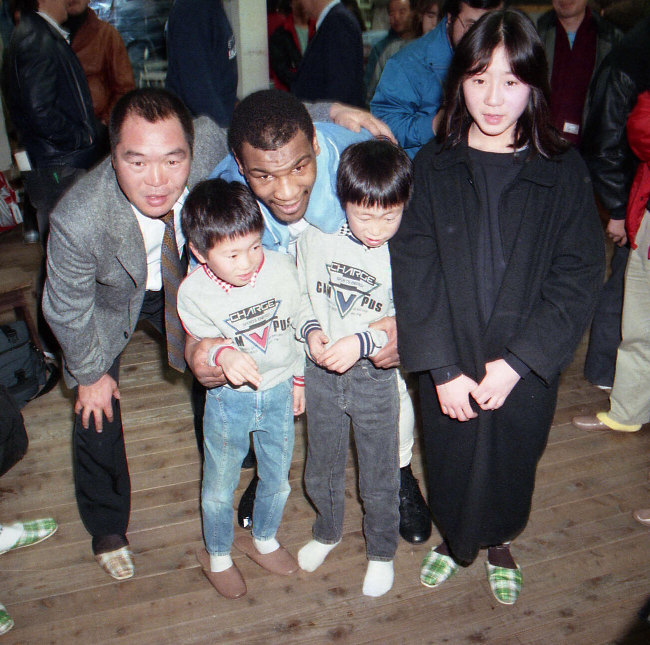 公開スパーリングが行われた帝拳ジムでマイク・タイソン（中央）と記念撮影するガッツ石松さん（左）と家族たち（1988年2月26日撮影）