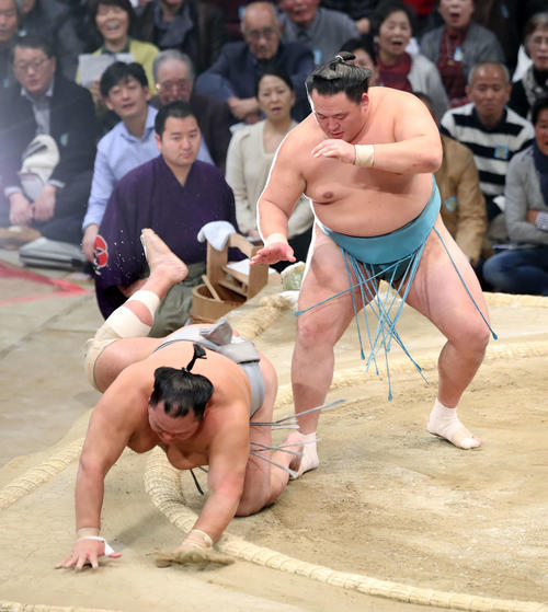 北勝富士（左）を送り倒しで破る玉鷲（撮影・鈴木正人）
