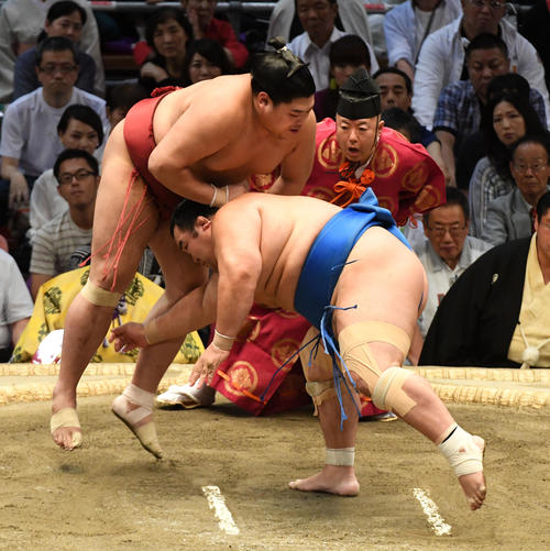 阿炎（左）は琴奨菊をはたき込みで破る（撮影・前岡正明）
