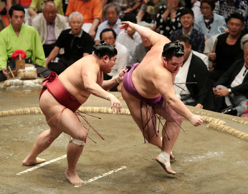 阿炎（左）の攻めを耐える朝乃山（撮影・鈴木正人）