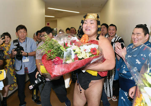 関係者から贈られた花束を手に花道を歩く大喜鵬（撮影・加藤諒）
