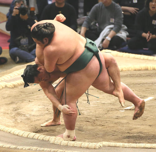 錦木（手前）を外掛けから三所攻めで破る石浦（撮影・栗木一考）