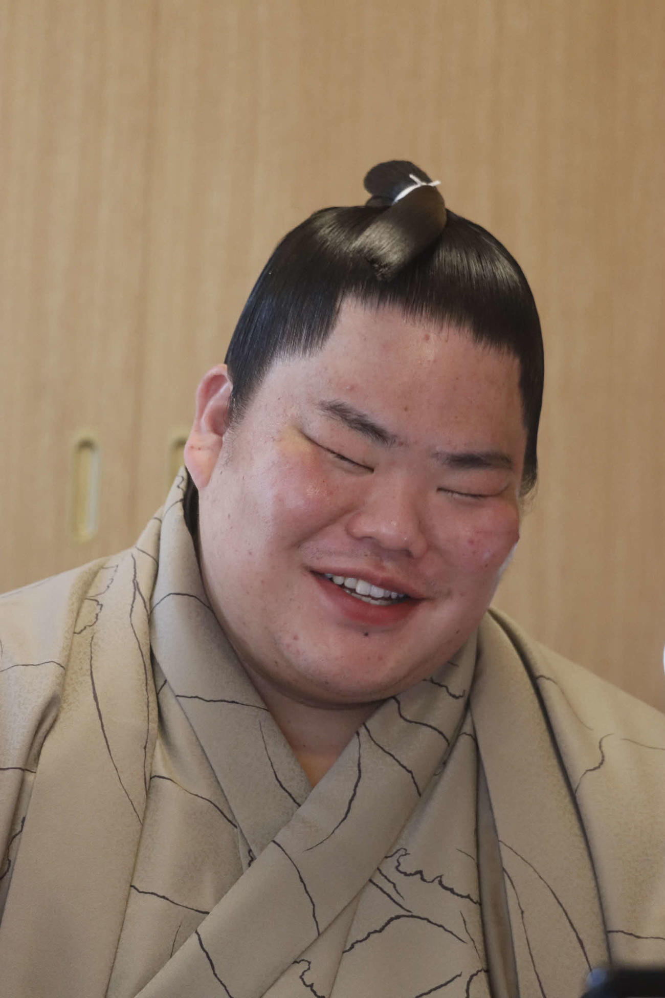 初優勝した初場所から一夜明け、リモートでの会見に出席して笑顔を見せる大栄翔（日本相撲協会提供）